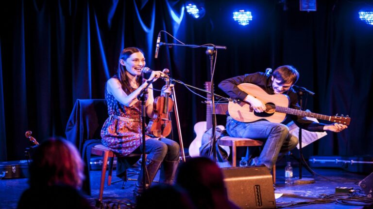 While others take in the vivid songs and bond over similar rhythms and people connecting with each other, two performers serenade with Latin music.